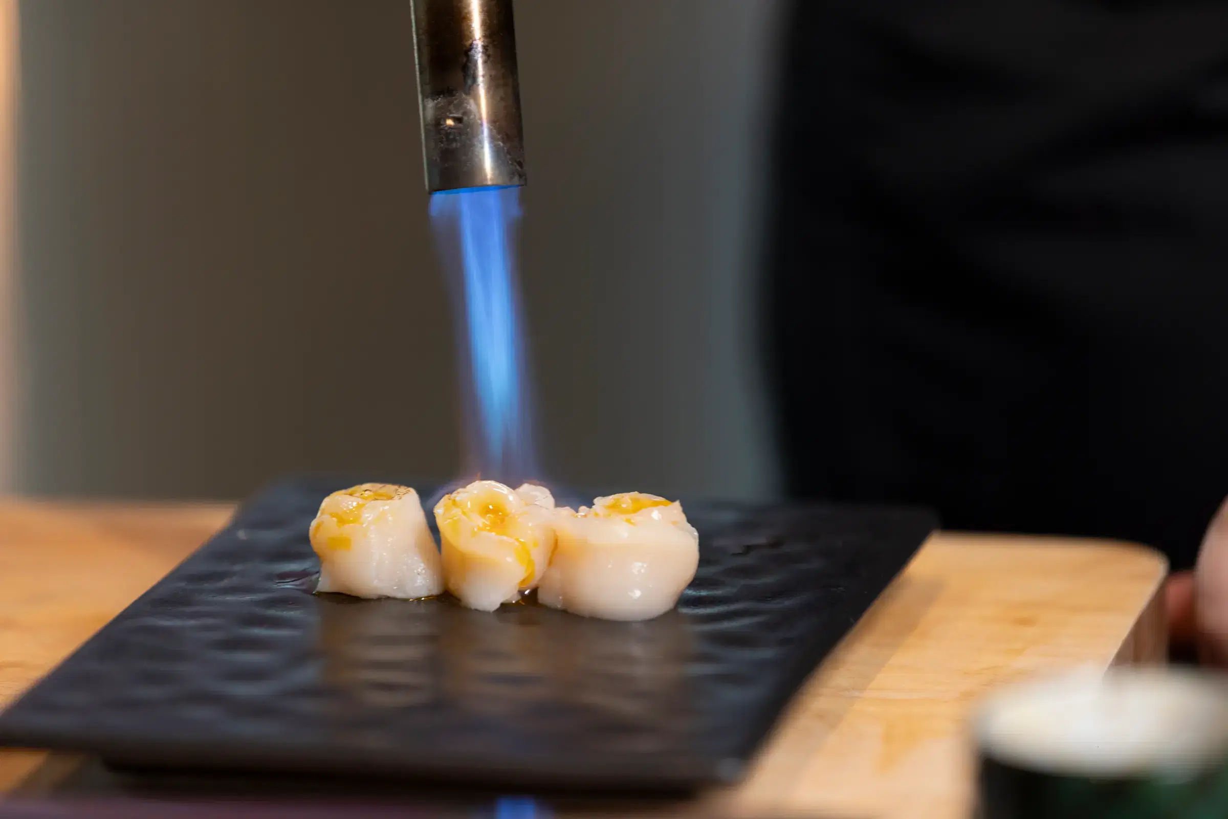 Guest savoring a piece of nigiri